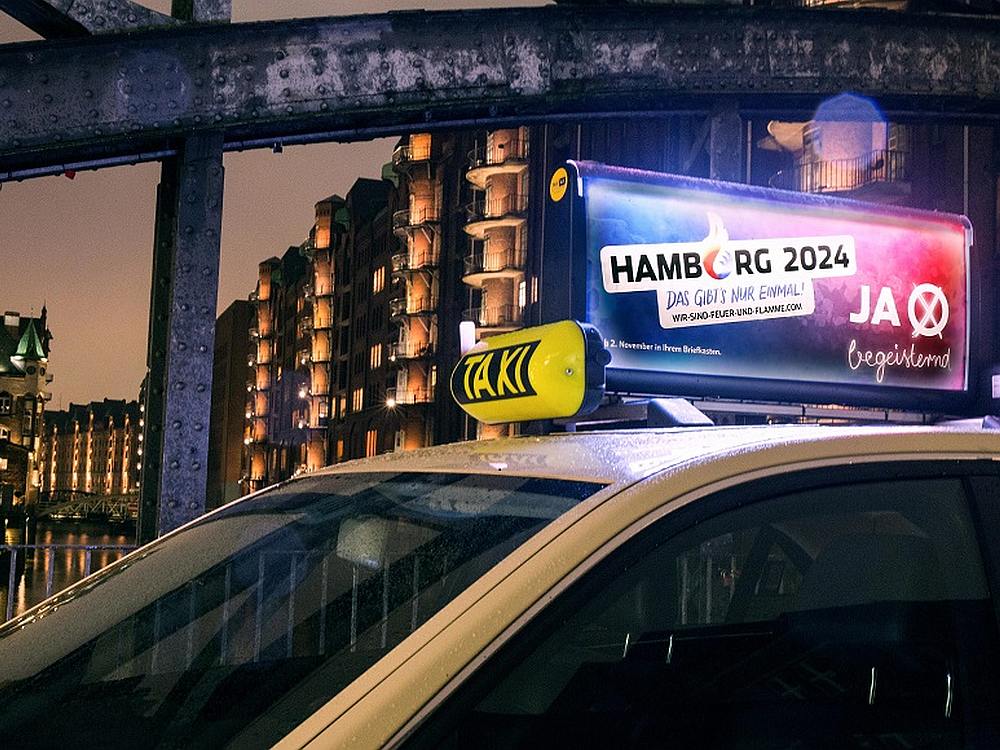 Rollen ab jetzt durch Hamburg - Taxen mit Werbung für die Pro Olympia 2024 Kampagne (Foto/ Rendering: TAXi-AD)
